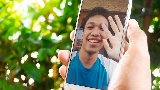 A man video call with family in pandemic coronavirus