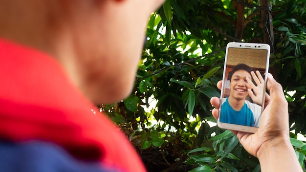 A man video call with family in pandemic coronavirus