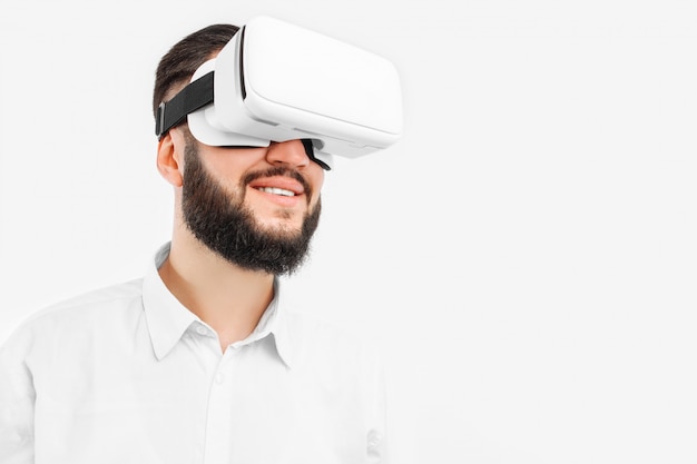 A man in virtual glasses, close-up, on a white wall