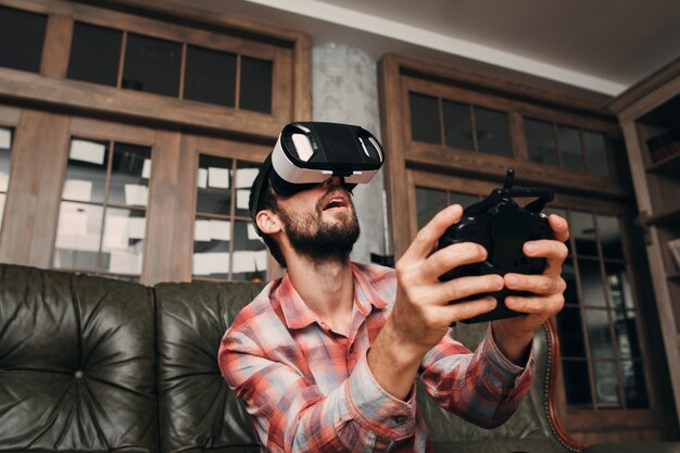 Man in vr glasses controlling something invisible.