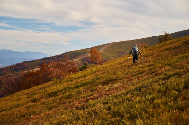 Man walking by mountain trail in Carpathian Mountains Ukraine Walking and hiking trails in Borzhava ridge Rural area of carpathian mountains in autumn