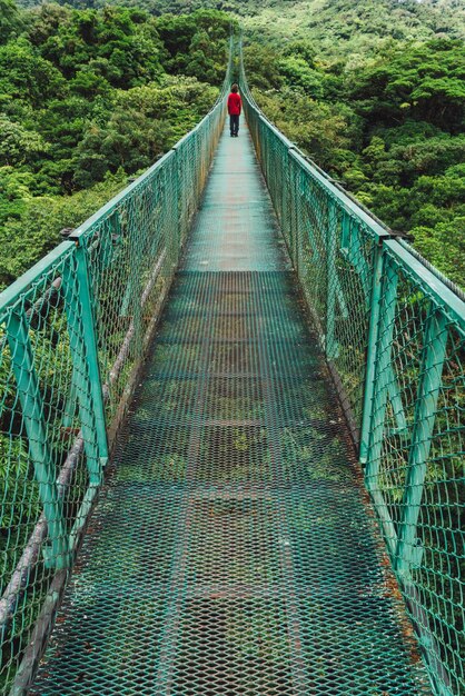 Man walking down a bridge