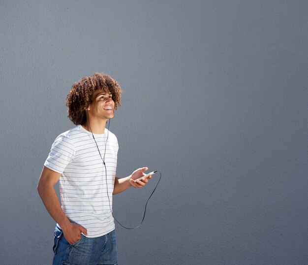 Man walking outside and listening to music with smart phone