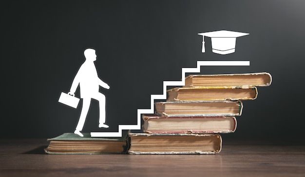 Man walking up stairs from books. Education. Knowledge. Success