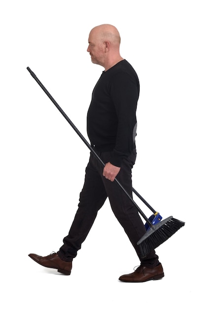 Man walking with a broom and dustpan on white background