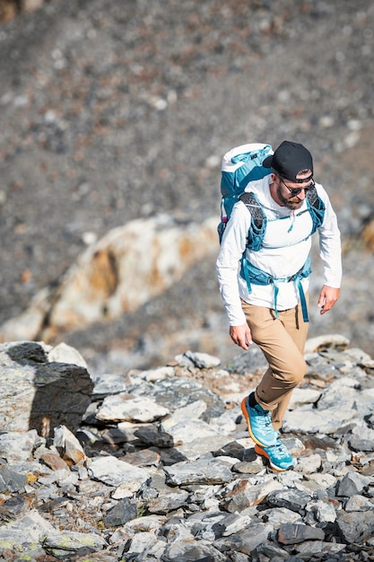 Man walks among boulders in the mountains