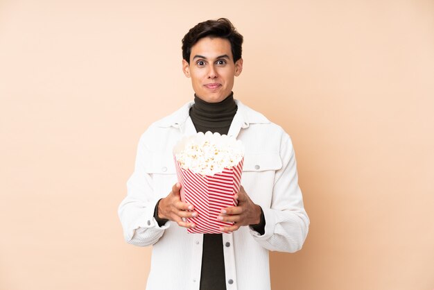 Man over wall holding a big bucket of popcorns