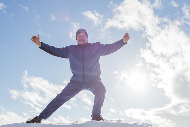 Man warming up before running in the winter on snow