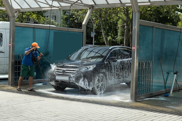 A man washes a car at a selfservice car wash