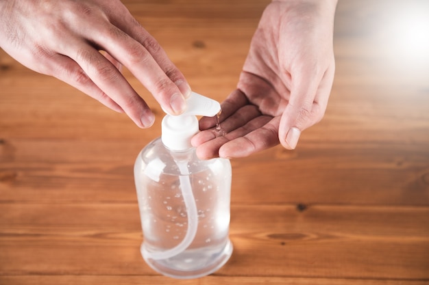 A man washes his hands with an antiseptic