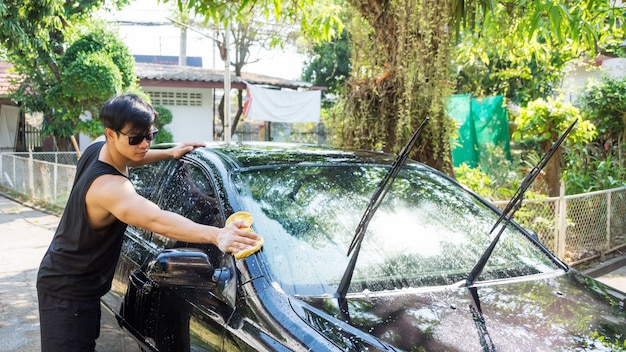 Man washing the black car.