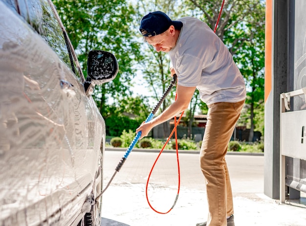 A man washing a car at a selfservice car wash