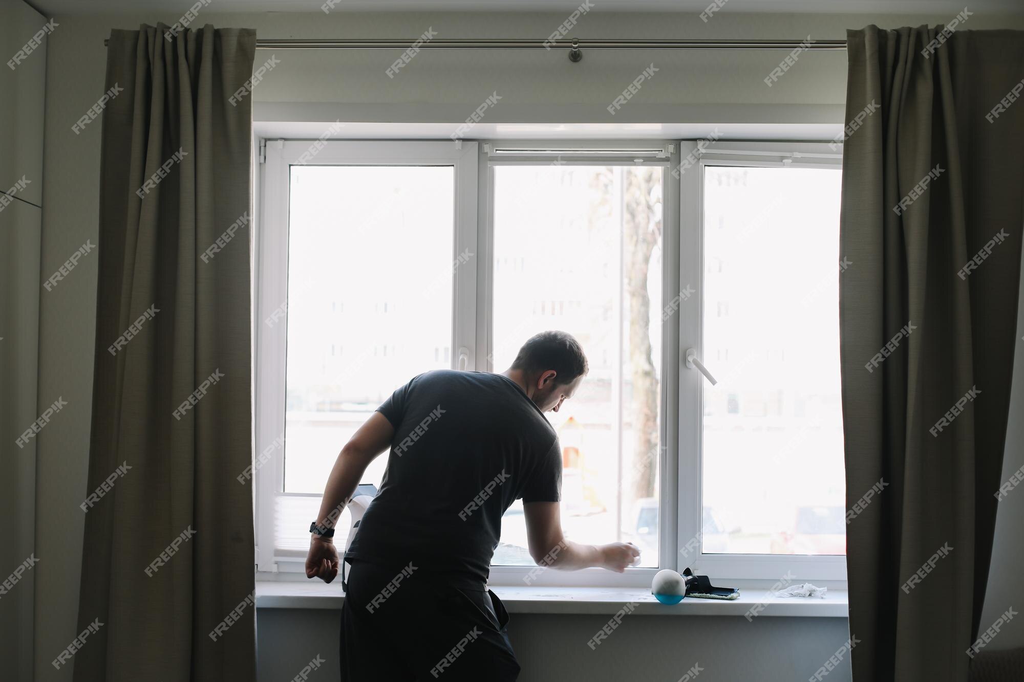 Premium Photo  Man washing and cleaning window at home housework