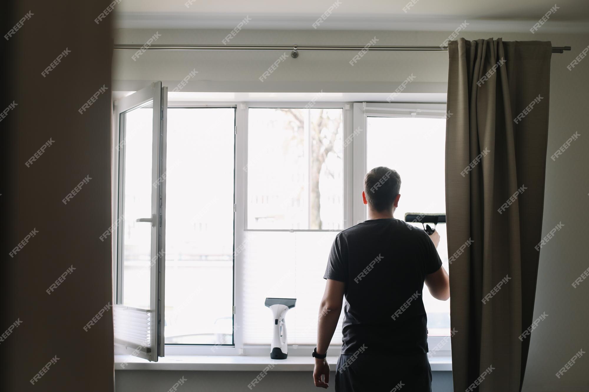 Premium Photo  Man washing and cleaning window at home housework