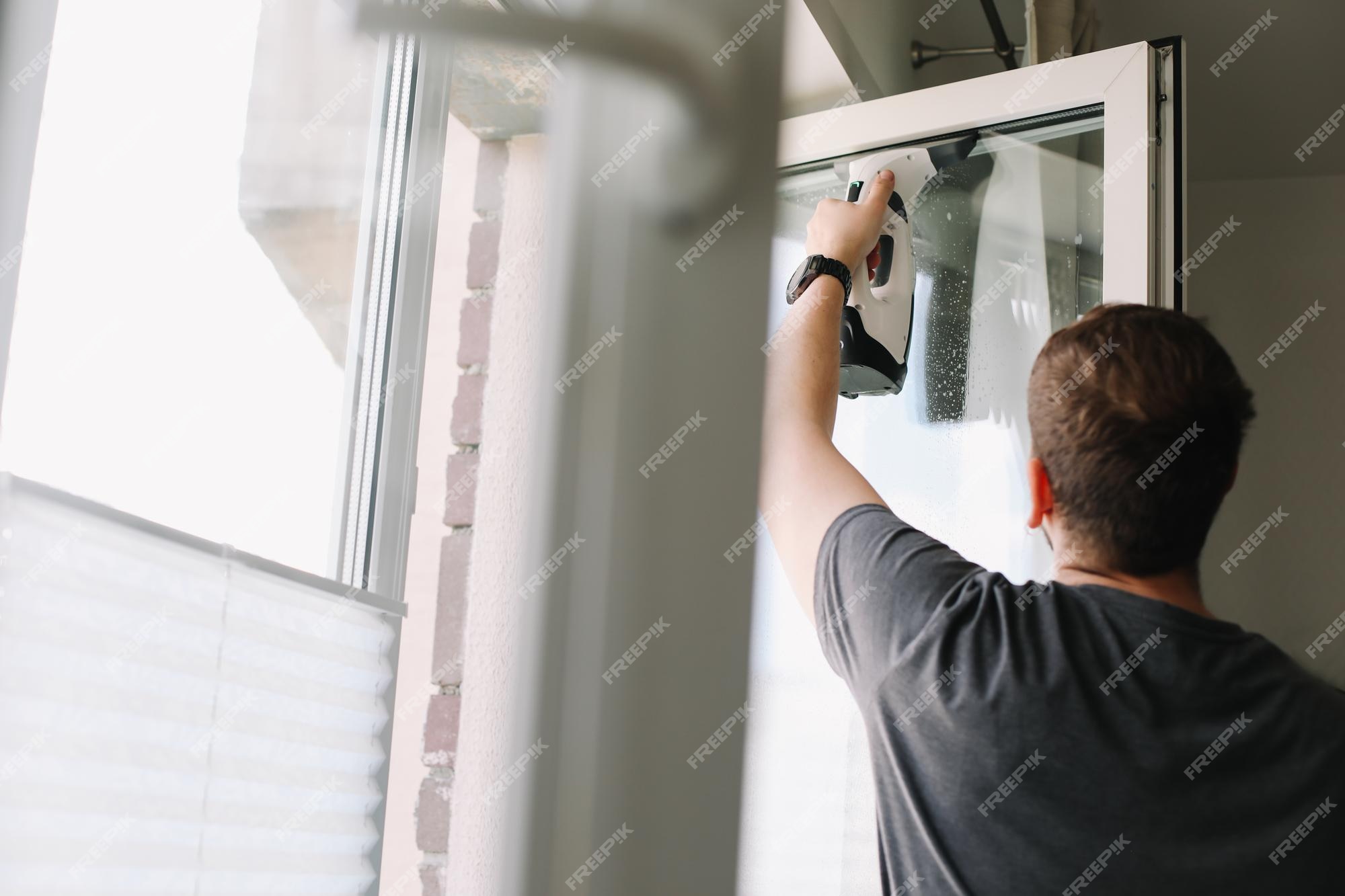 Premium Photo  Man washing and cleaning window at home housework