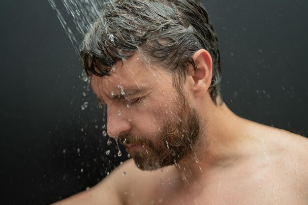 Man washing hair in bathroom guy bathing shower head in bathtub male face in shower man taking