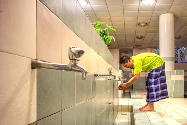 Photo man washing hands in bathroom