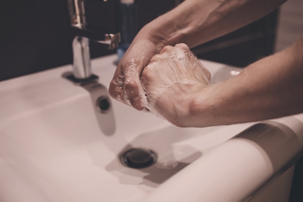 Foto mani di lavaggio uomo con sapone