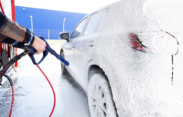 The man washing his car on self-service car wash