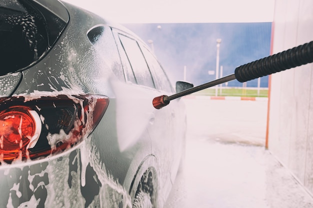 The man washing his car on self-service car wash