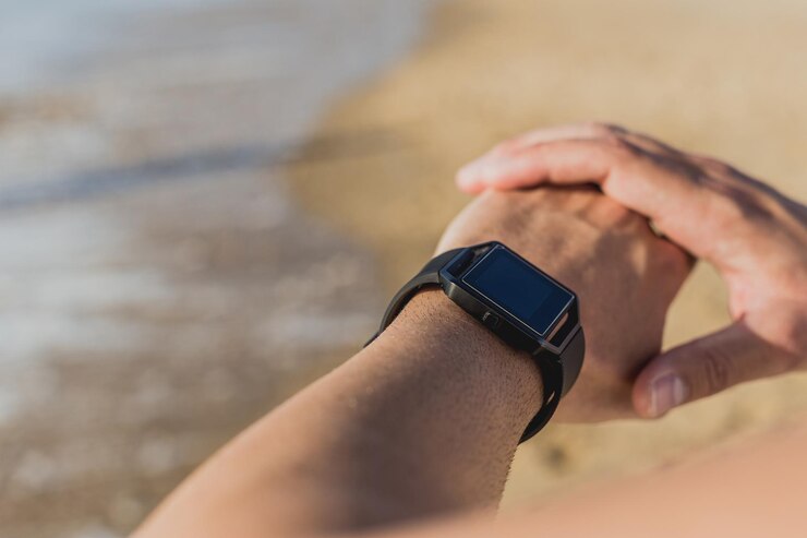 Photo a man and a watch are sitting on the beach