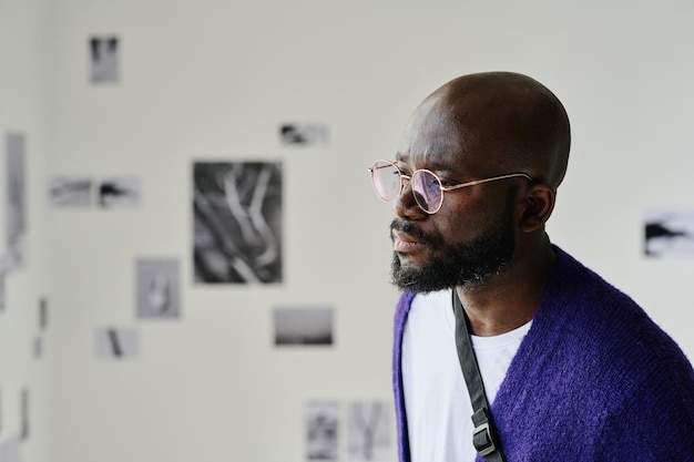 Man watching at pictures at gallery