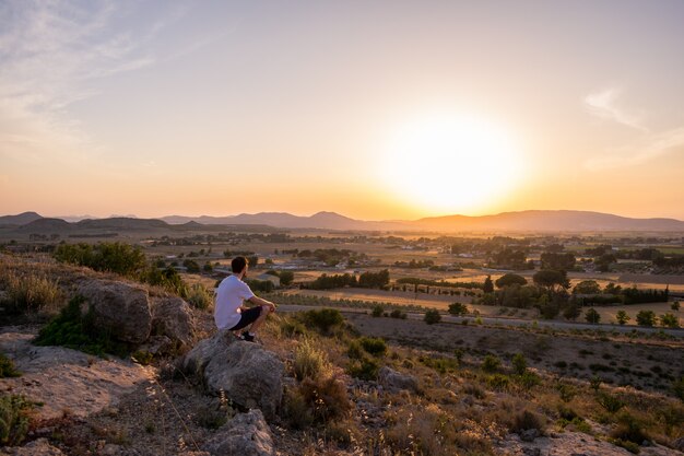 Man watching the sunset in a mountain