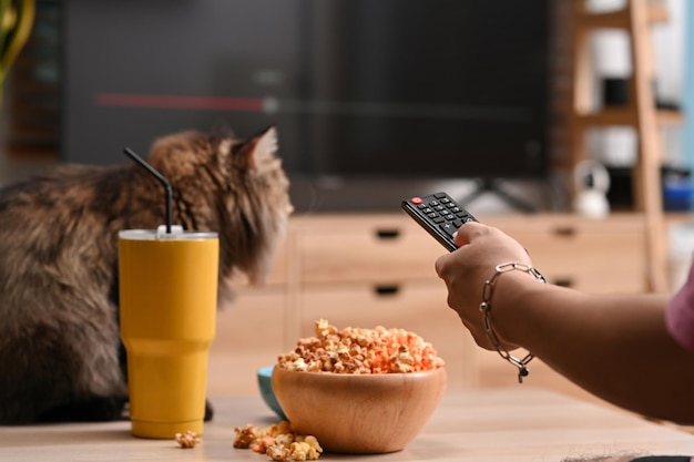 Man watching tv and eating popcorn on couch at home