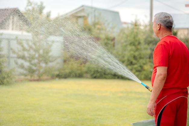 Man watering lawn irrigation system lawn sprinkler