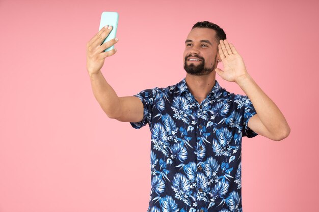 Man waving while making a video call with his cell phone