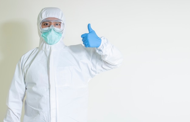 Photo man wear hazmat suit protect contagious disease  covid-19 thumbs up isolated on white background