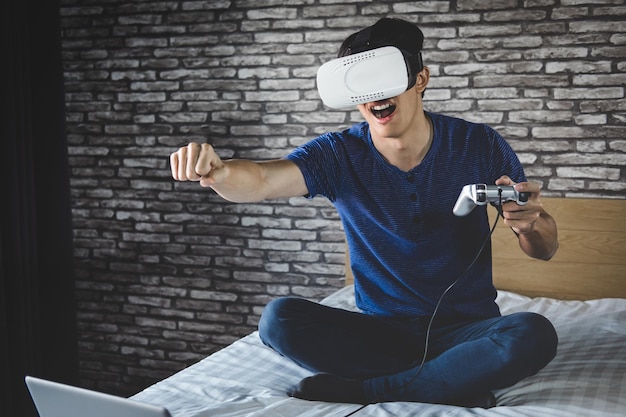 Man wearing 3d glasses while playing video game at home