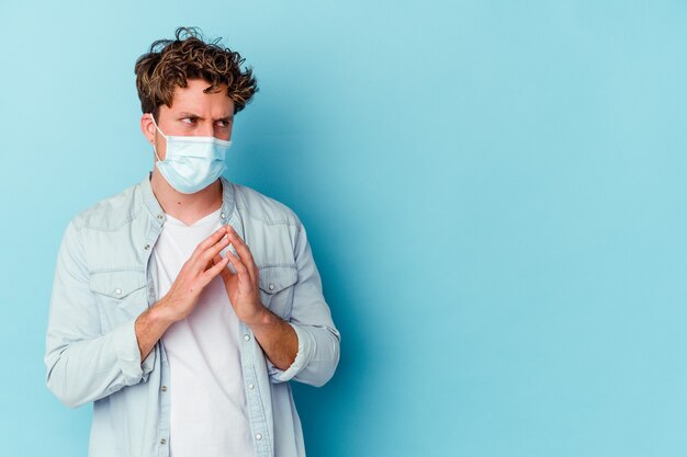 man wearing an antiviral mask isolated on blue