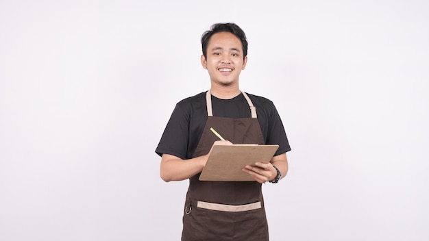 The man wearing the apron stands on an isolated white background with a menu list