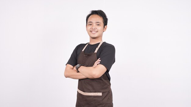 The man wearing the apron stands on an isolated white background