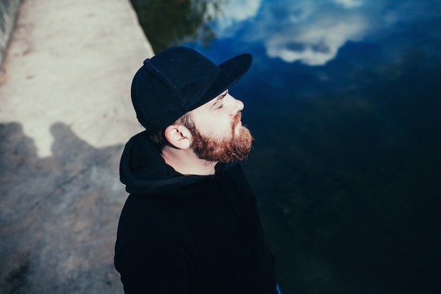 Man wearing black blank cap.