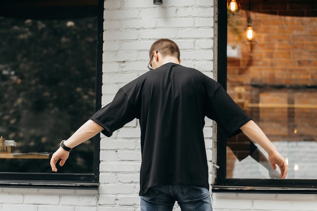 Man wearing black blank tshirt with space for your logo or design Mock up