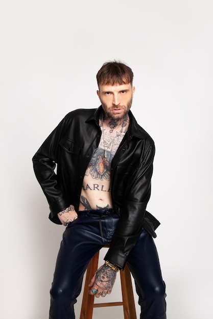 a man wearing a black leather jacket with the word marl on the chest.
