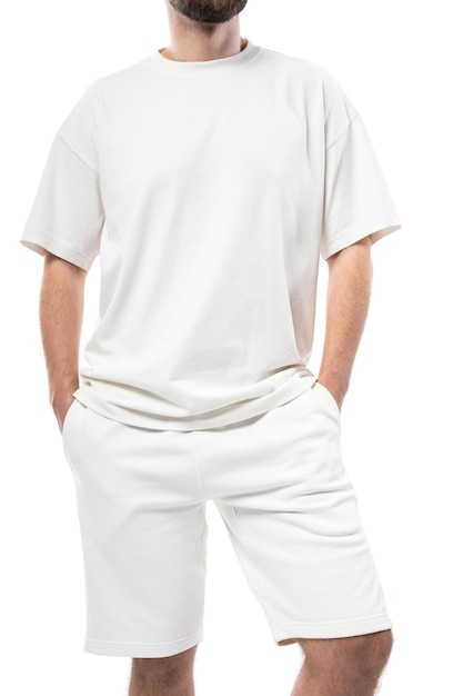 Man wearing blank white t-shirt and shorts isolated on white background