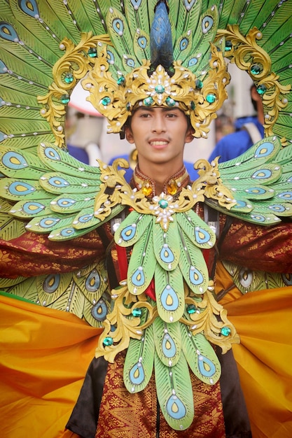 a man wearing a costume with a green and blue design on it