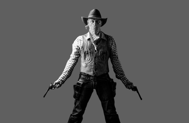 Man wearing cowboy hat, gun. West, guns. American bandit in mask, western man with hat. Portrait of farmer or cowboy in hat. Cowboy with weapon on background. Black and white.