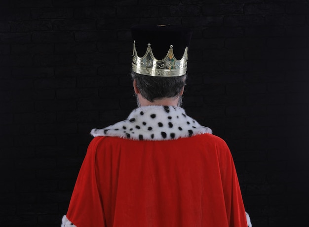 A man wearing a crown with the word king on it