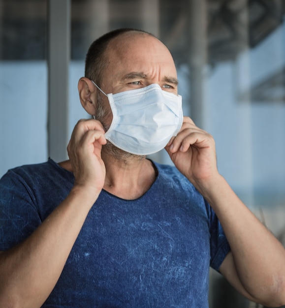 Man wearing facial disposable mask to avoid viral infection. Virus protection