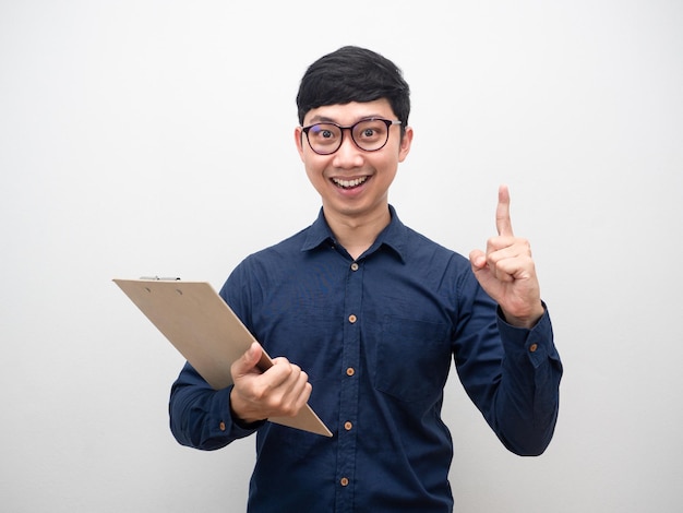 Man wearing glasses holding clipboard with backpak gesture get ideas finger up