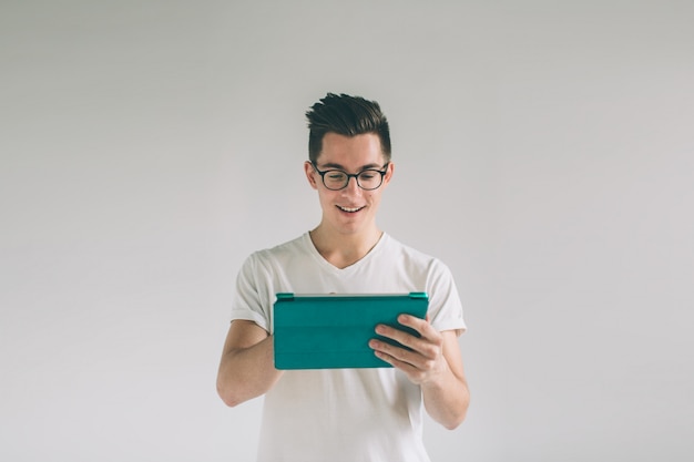 Man wearing glasses holds a tablet