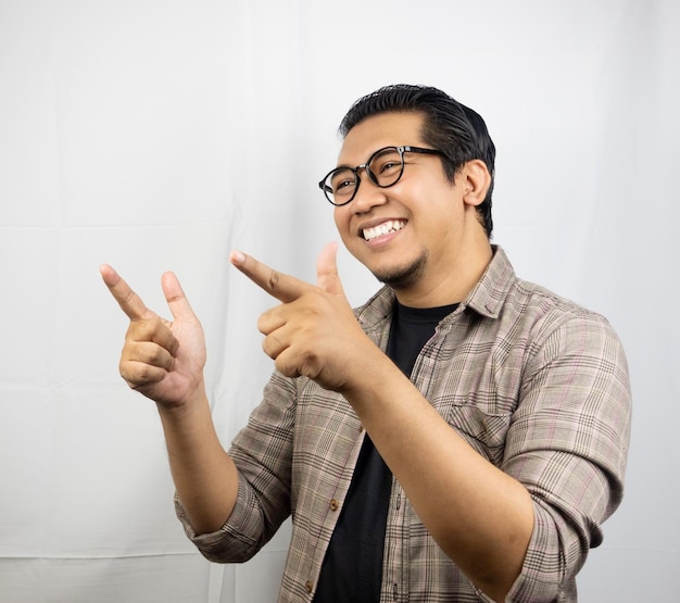 a man wearing glasses and a shirt with a shirt that says " he is pointing ".