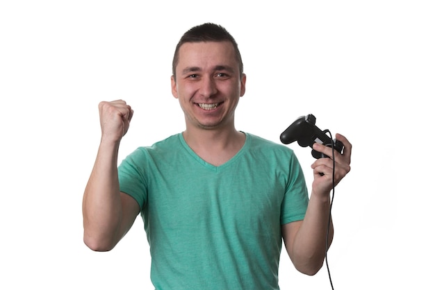 Man Wearing A Green Tshirt And He Is Playing Video Games  Over White Background Isolated