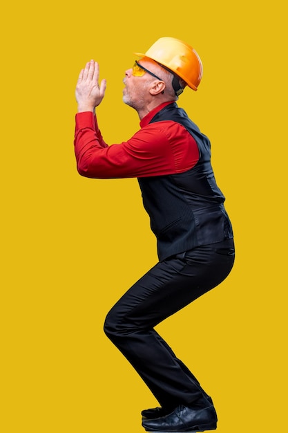 A man wearing a hard hat and black pants