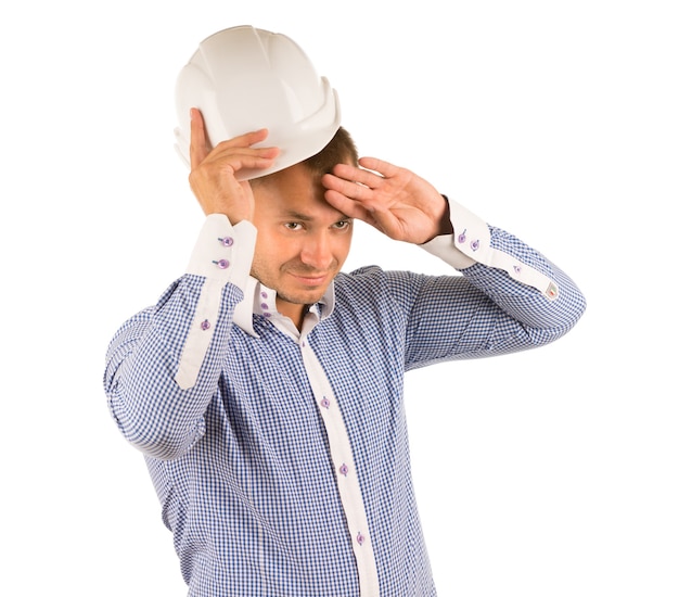 Man Wearing Hard Hat Wiping Forehead with Hand