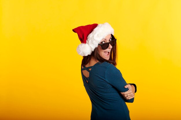 Man wearing hat standing against yellow background